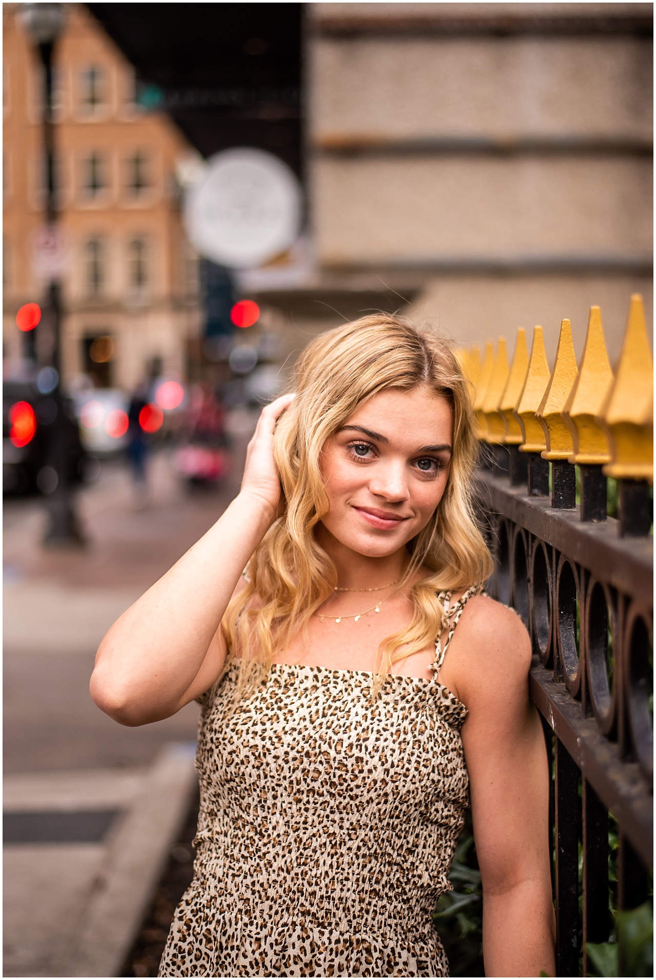 Blonde girl wearing leopard jumpsuit standing in street in downtown Knoxville, Tennessee.